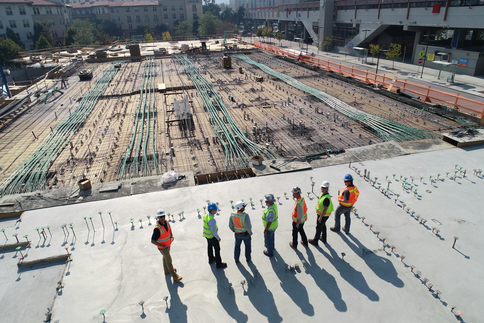 Roofing professionals reviewing a commercial building roof area